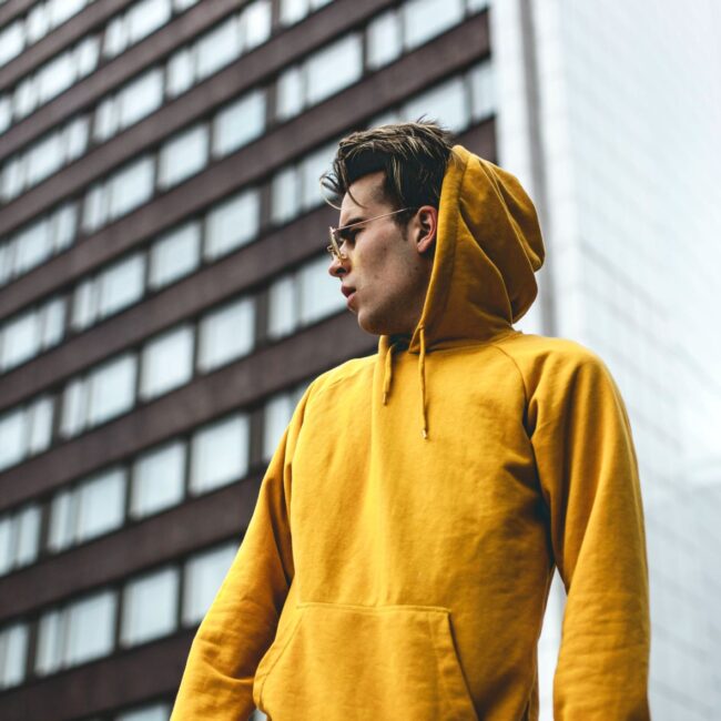 guy in yellow hoodie from UK sustainable fashion brand