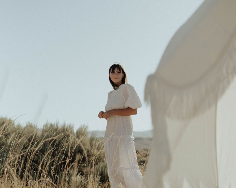 Girl on beach in sustainable summer dress