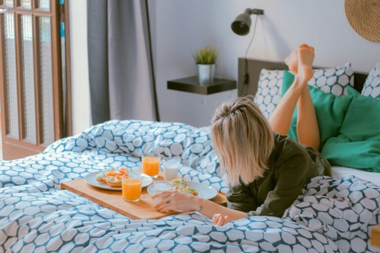Girl having breakfast on her bed